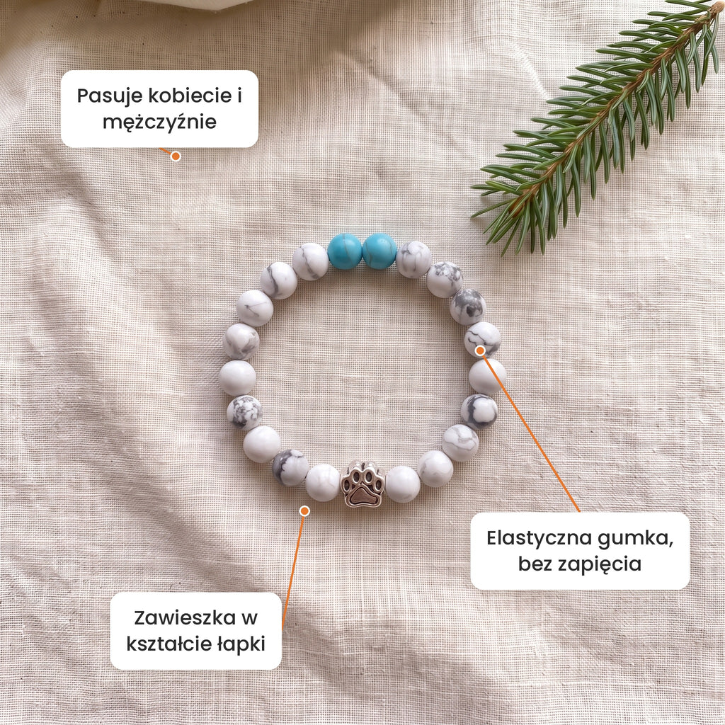 Cechy: Bransoletka Brzozowy Gaj. Zawieszka w kształcie łapki, elastyczna gumka bez zapięcia, pasuje kobiecie i mężczyźnie