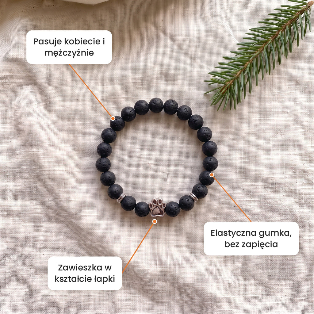 Cechy: Bransoletka Czarna Kora. Zawieszka w kształcie łapki, elastyczna gumka bez zapięcia, pasuje kobiecie i mężczyźnie