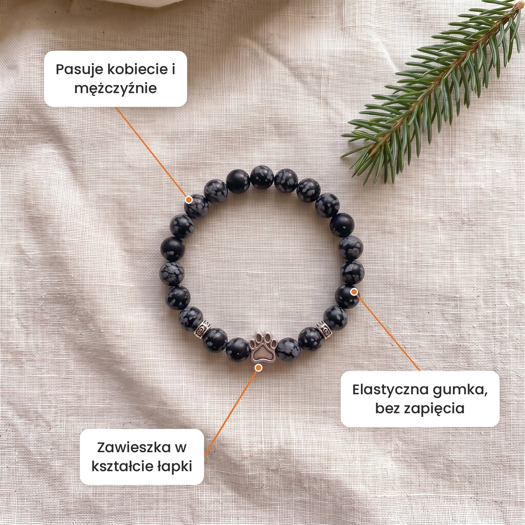 Cechy: Bransoletka Grudniowy Zmierzch. Zawieszka w kształcie łapki, elastyczna gumka bez zapięcia, pasuje kobiecie i mężczyźnie