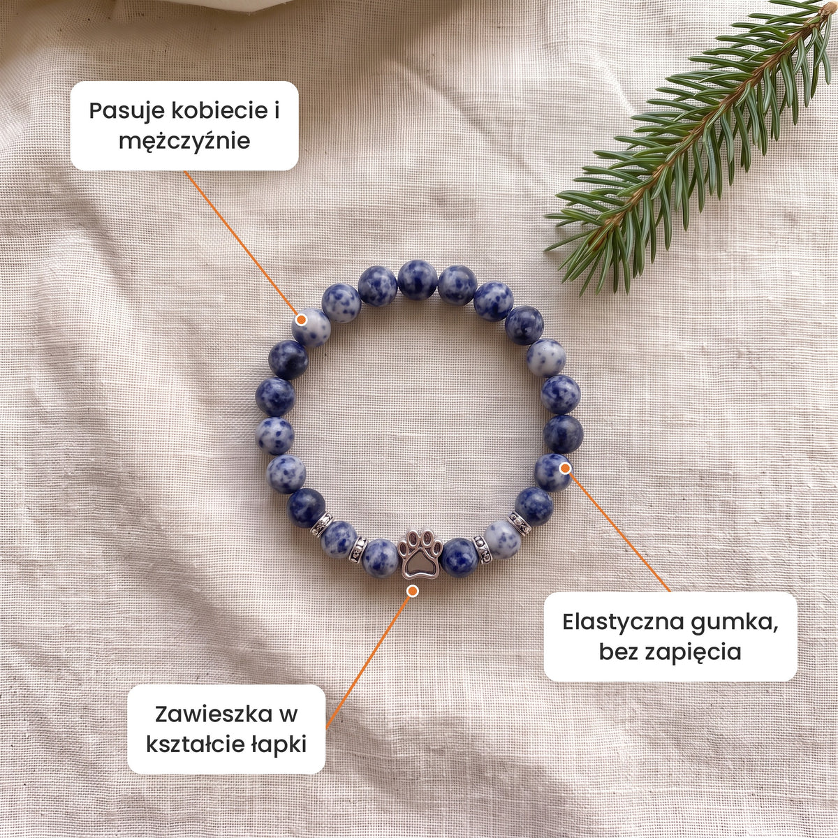 Cechy: Bransoletka Mroźny Poranek. Zawieszka w kształcie łapki, elastyczna gumka bez zapięcia, pasuje kobiecie i mężczyźnie
