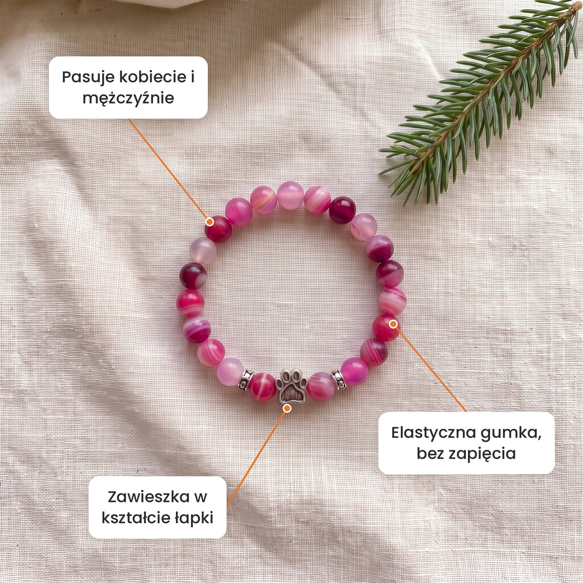 Cechy: Bransoletka Poranna Zorza. Zawieszka w kształcie łapki, elastyczna gumka bez zapięcia, pasuje kobiecie i mężczyźnie