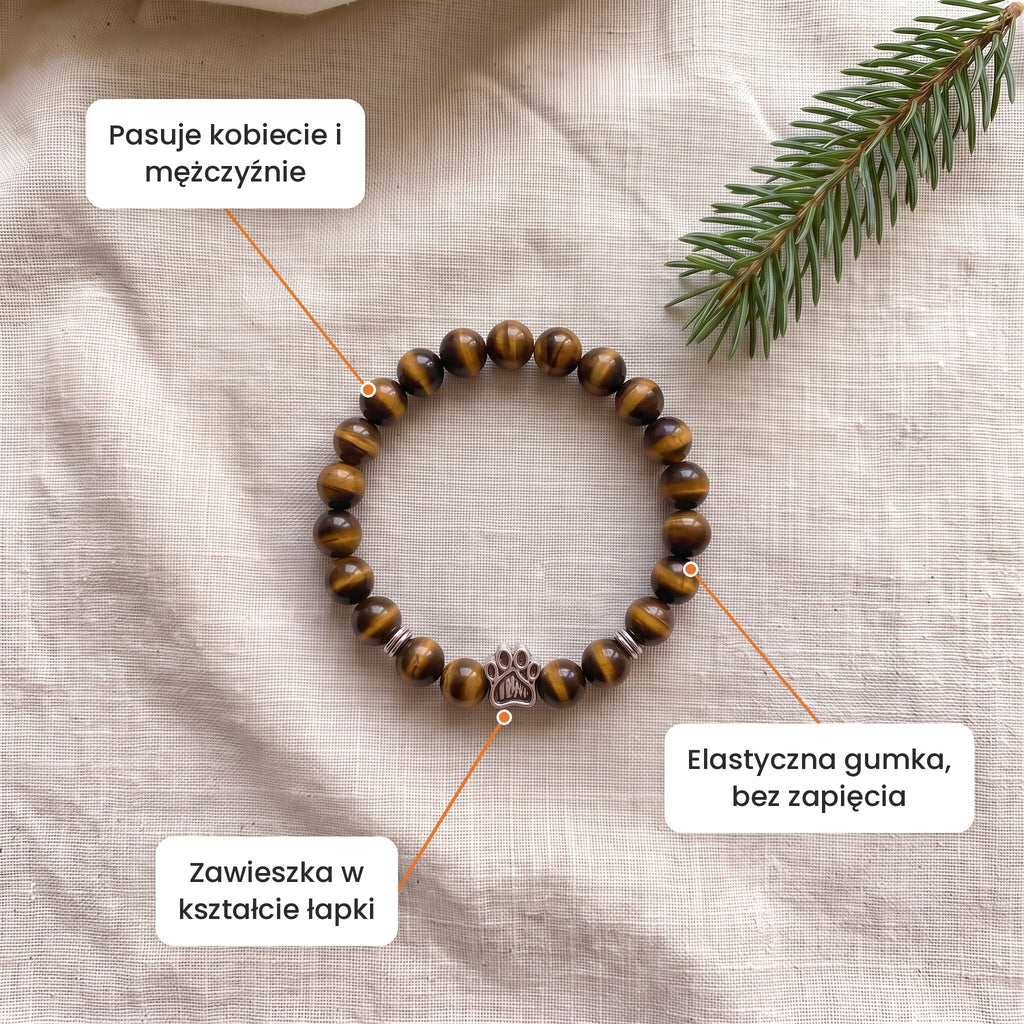Cechy: Bransoletka Złota Godzina. Zawieszka w kształcie łapki, elastyczna gumka bez zapięcia, pasuje kobiecie i mężczyźnie
